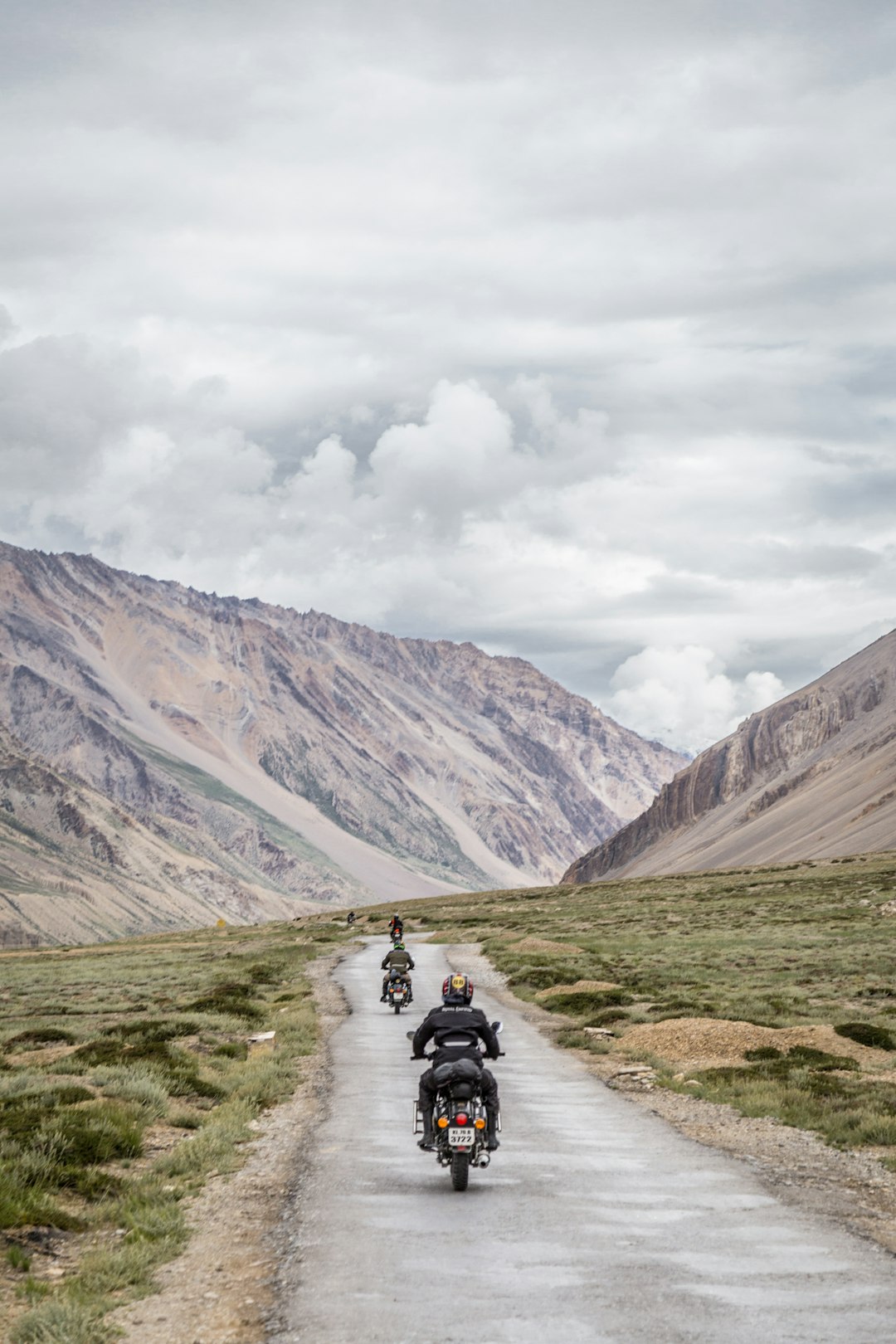 two-motorcycles-driving-on-grey-road-slf40jiv82s